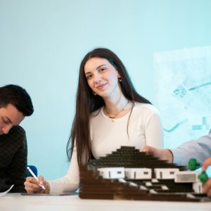 A young woman working and writing something - Fostering Innovation