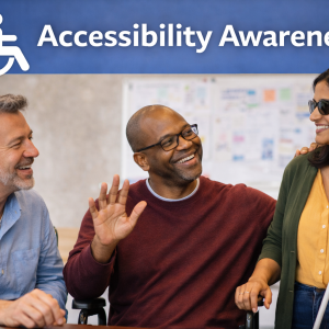 Three adults smiling and talking beneath an Accessibility Awareness sign with a wheelchair symbol.