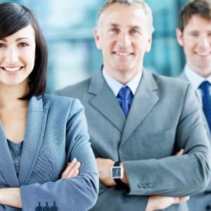 Three professionals in suits smile confidently under the text: Business Acumen - Self Study.