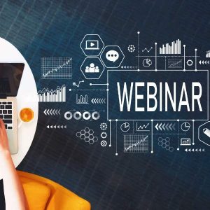 Person at laptop viewing “Creating a Great Webinar - Self Study” with icons on dark screen.