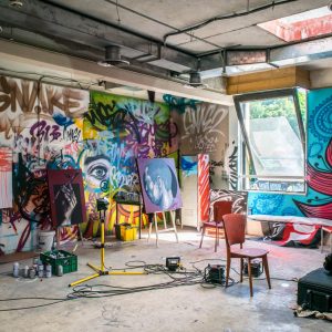 Creativity: Thinking Outside the Box - Self Study in a sunlit studio with graffiti and paintings.