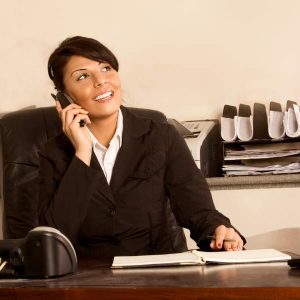 Businesswoman at desk on phone with planner; Executive and Personal Assistants Self Study shown.