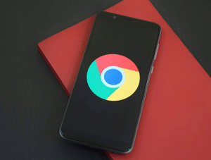 Smartphone displaying “Google Workspace - Self Study,” placed on a closed red notebook.