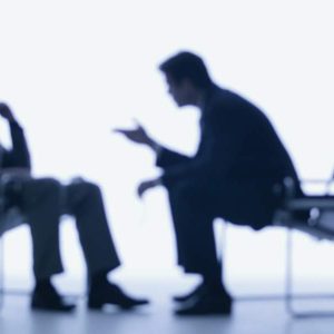 Two professionals talking in a bright room with text: In-Person Sales - Self Study training.