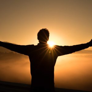 Silhouette with outstretched arms at sunrise, radiating positivity with text: “Increasing Your Happiness.”.