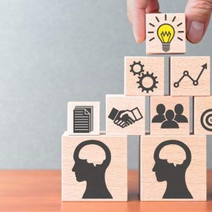 Nine business icon blocks stacked in a pyramid, titled Knowledge Management - Self Study.