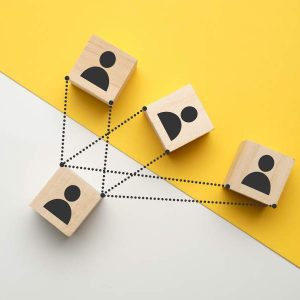 Four wooden blocks with people icons on a yellow and white background, text: Manager Management - Self Study.