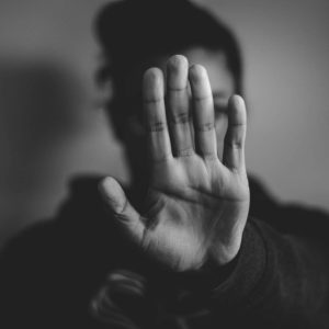 Person holding up hand in stop gesture; text: Managing Workplace Harassment - Self Study.