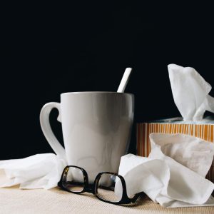 Office Health and Safety - Self Study course, mug, tissue box, tissues, and glasses on table.